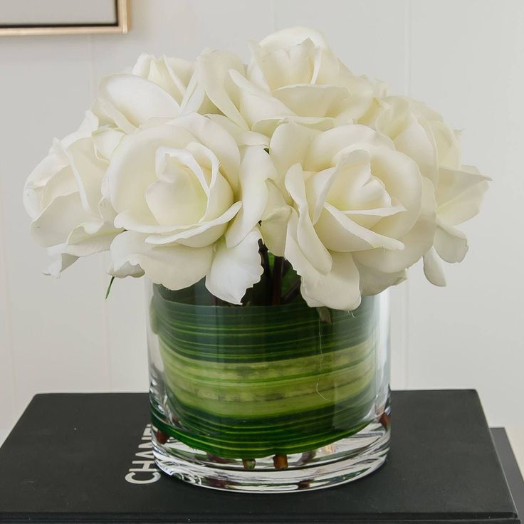 there is a vase with white flowers in it