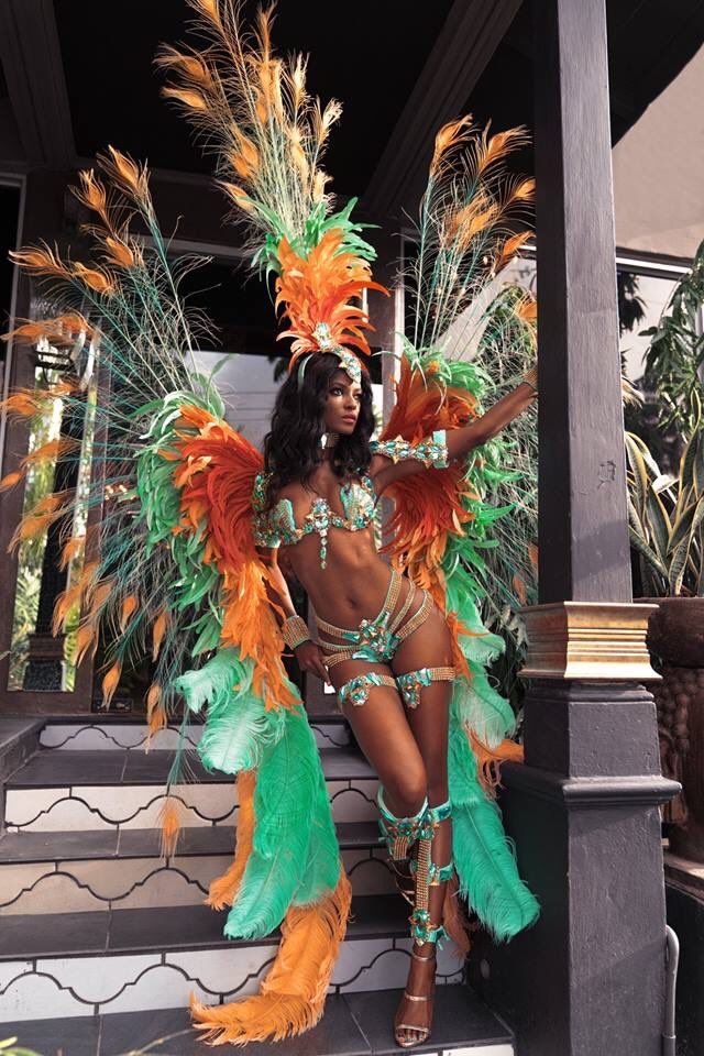 a woman in a colorful costume sitting on the steps with her hands behind her head