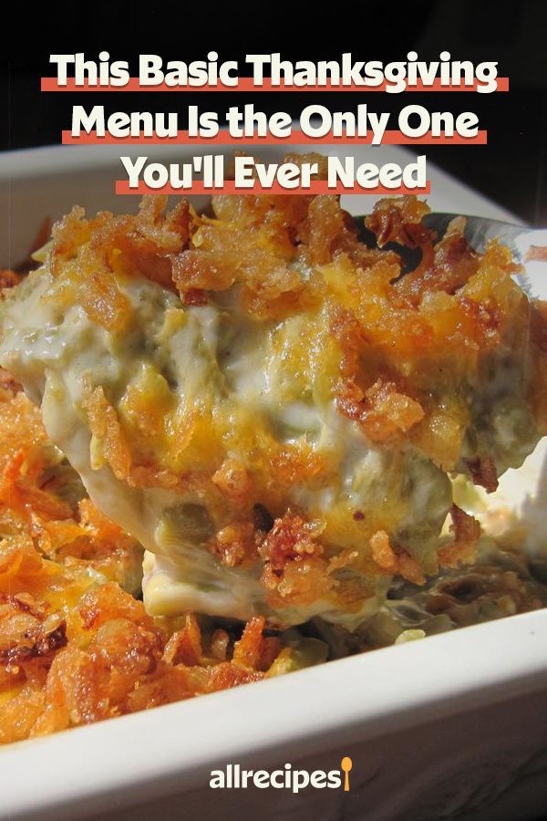 a white casserole dish filled with meat and cheese, topped with a fork