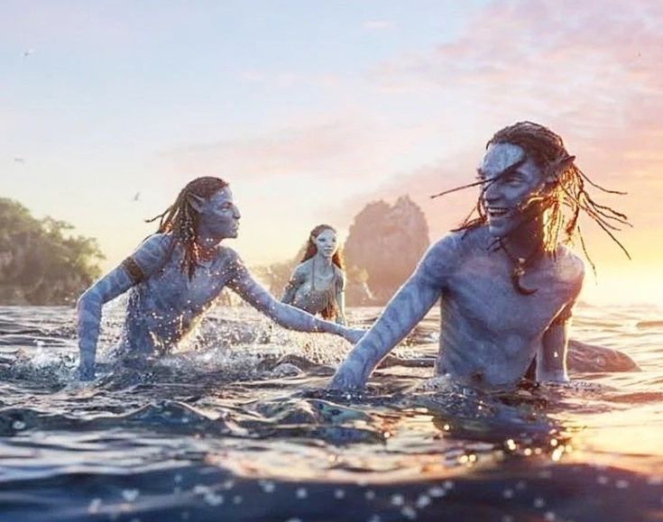 two people in the water with dreadlocks on their heads and one holding hands