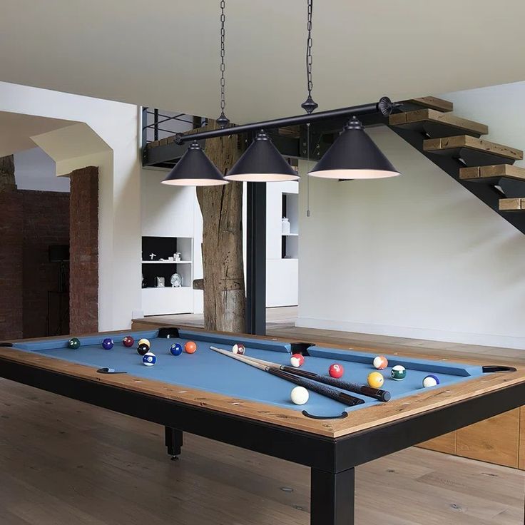 a pool table with two lamps hanging over it