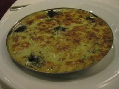 a white plate topped with an omelet on top of a table