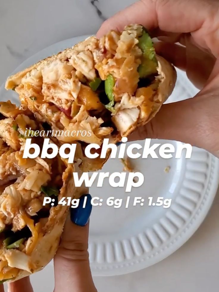 a person holding a chicken wrap on top of a white plate with the words bbq chicken wrap