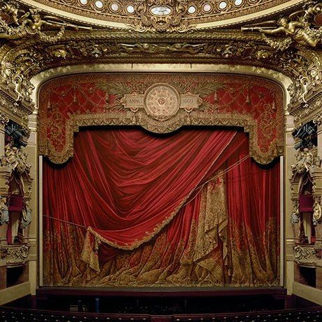 an ornately decorated stage with red curtains