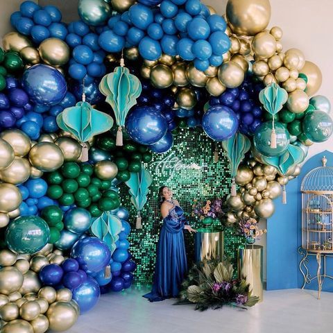 a woman standing in front of a bunch of balloons