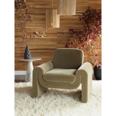 a chair sitting on top of a white rug in front of a wall with wooden paneling