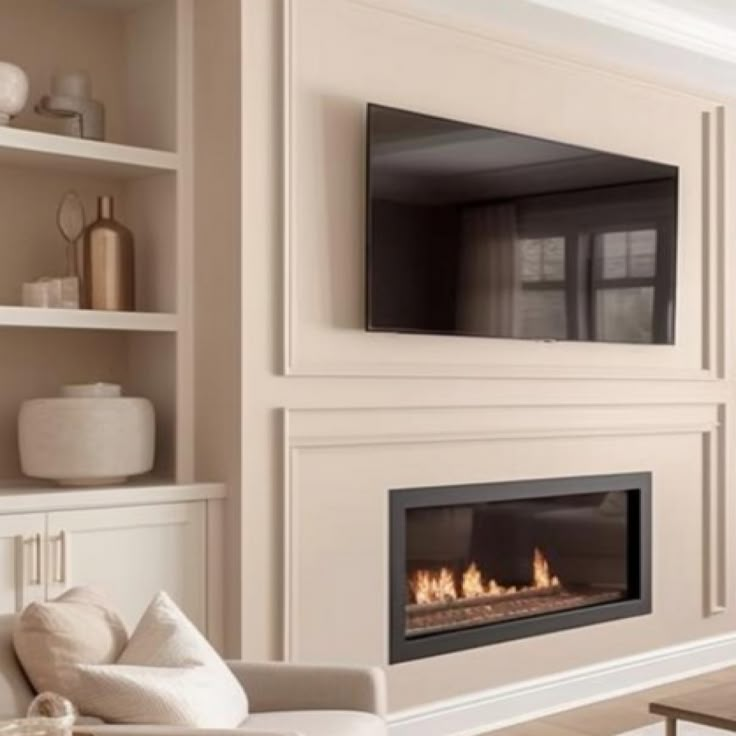 a living room filled with furniture and a flat screen tv mounted on the wall above a fire place