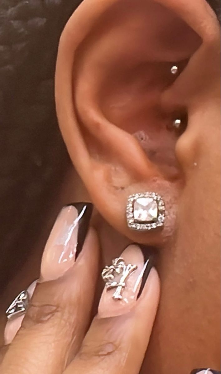 a close up of a person's ear and nails