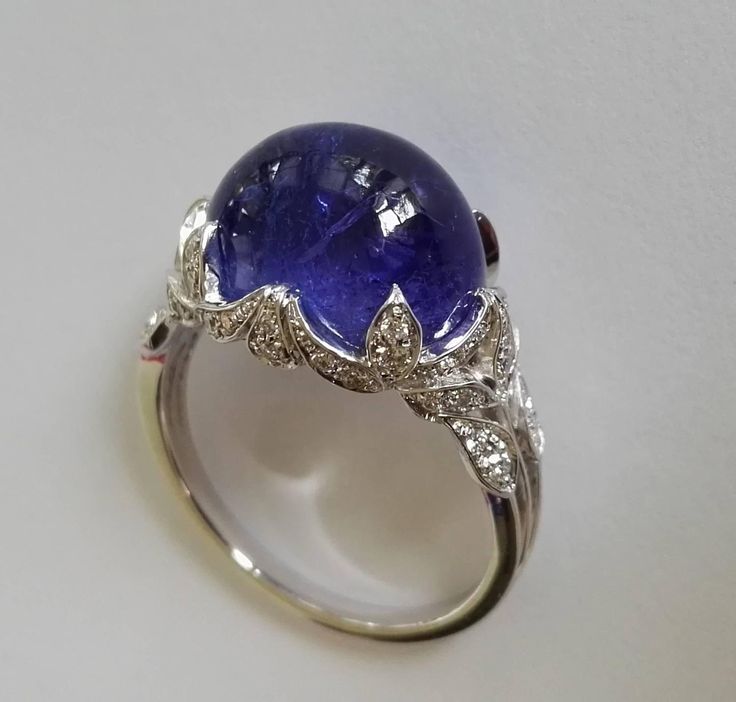 Dalben Tanzanite Diamond Gold Ring | From a unique collection of vintage cocktail rings at https://www.1stdibs.com/jewelry/rings/cocktail-rings/ Luxury Diamond Cabochons For Formal Occasions, Luxury Cabochon Diamond Ring For Formal Occasions, Luxury Formal Cabochon Diamond Ring, Luxury Domed Cabochons For Formal Occasions, Oval Diamond Cabochons For Formal Occasions, Formal Hallmarked Diamond Cabochons, Luxury White Gold Dome Ring In Platinum, Luxury Domed Cabochons For Anniversary, Luxury White Gold Diamond Cabochons