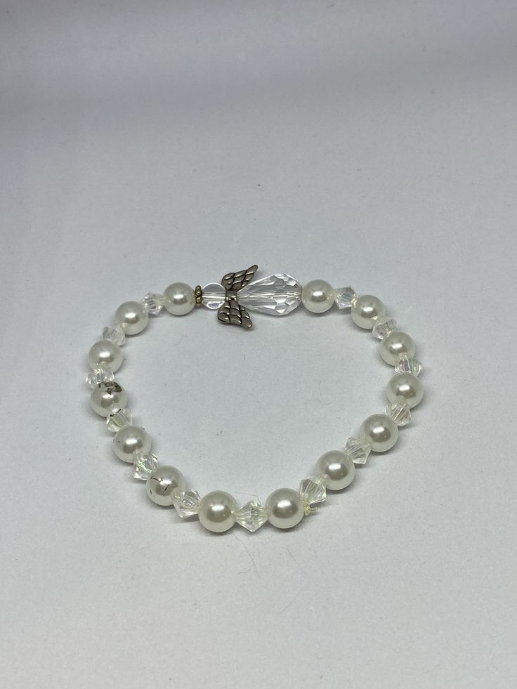 This a Guardian Angel Bracelet. It would make a perfect gift for a woman's Birthday.  It has a clear Angel with silver wings in the middle. It has white pearl beads. It also has clear bicone beads. It was made with .8mm sturdy stretch string. I tie it several times to prevent breakage.  It fits most women. It stretches to fit on the wrist. ###All items are ready to be shipped I do combined shipping. Items ship in 2-5 business days. Check out more items at: http://www.etsy.com/shop/MesheleCrafts Bloomington Illinois, Angel Bracelet, Women Bracelets, Bracelets Women, Bracelets Diy, Silver Wings, Beaded Bracelets Diy, Birthday Woman, Guardian Angel