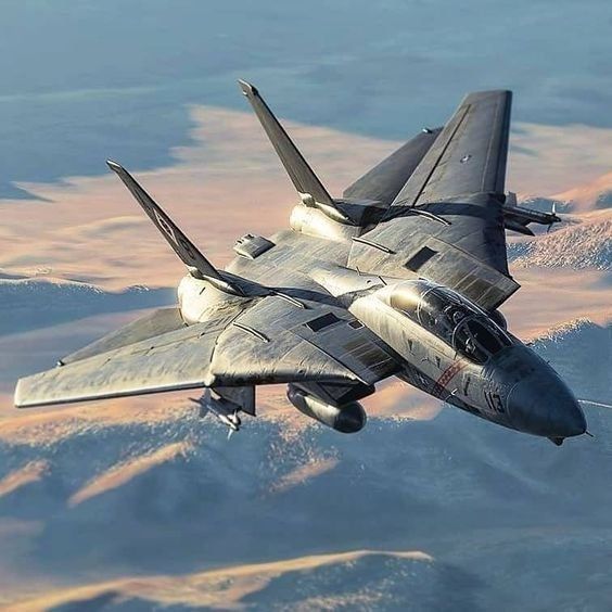 a fighter jet flying through the sky over mountains