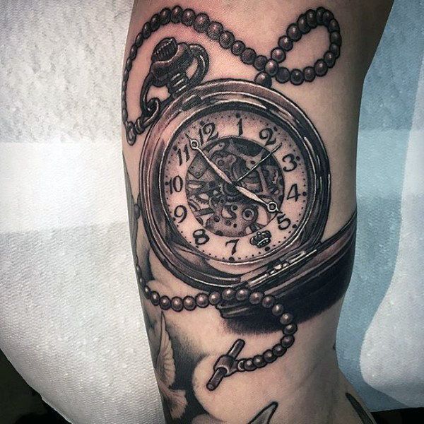 a black and white photo of a pocket watch tattoo