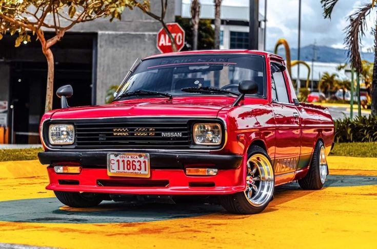 a red truck parked in front of a stop sign