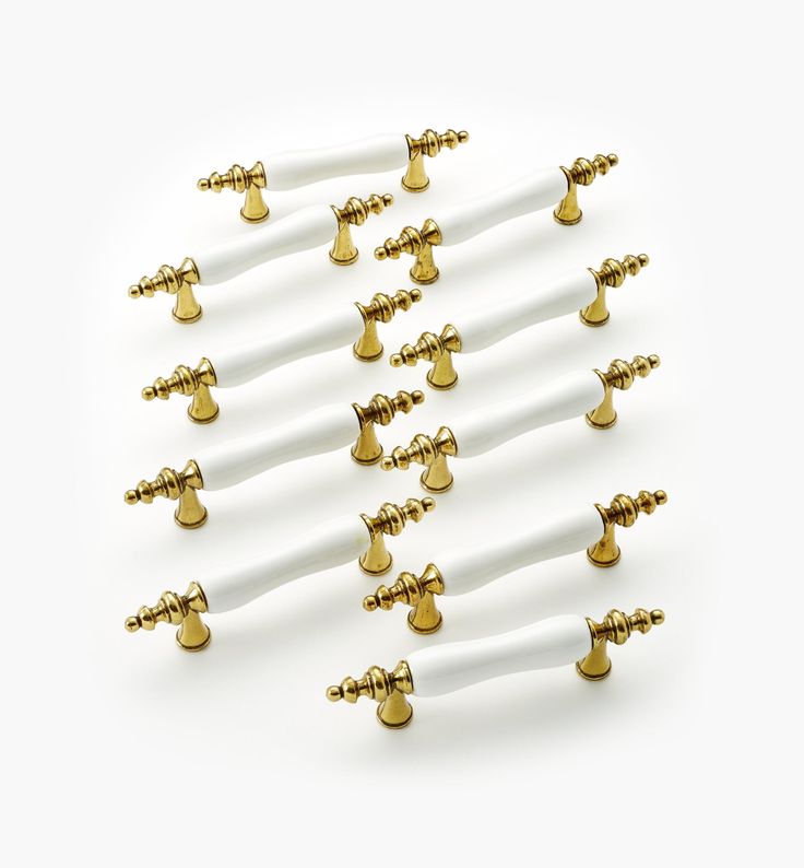 a bunch of white and gold screws on a white background