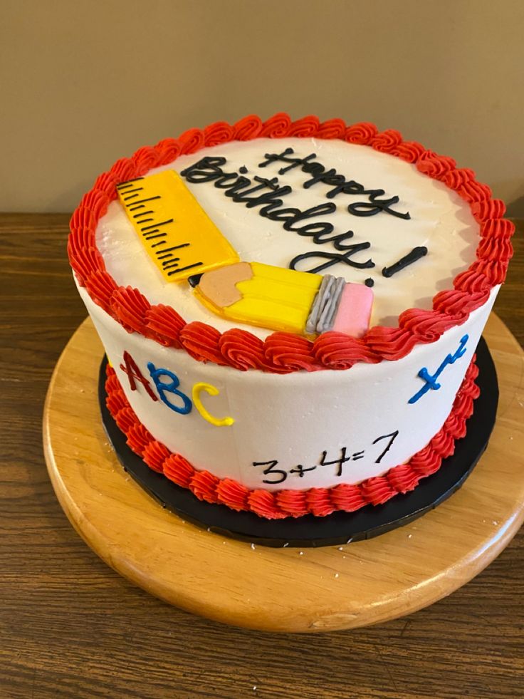 there is a cake that has been decorated with school supplies