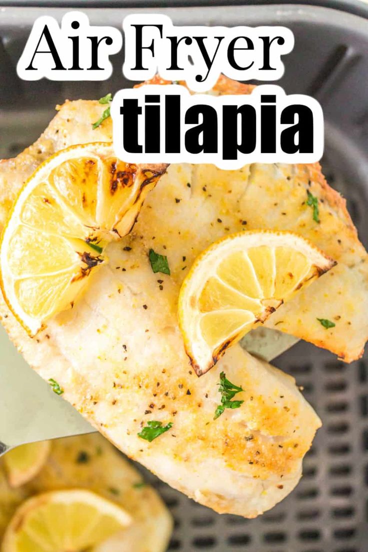 air fryer tilapa with lemons and parsley on top in a skillet