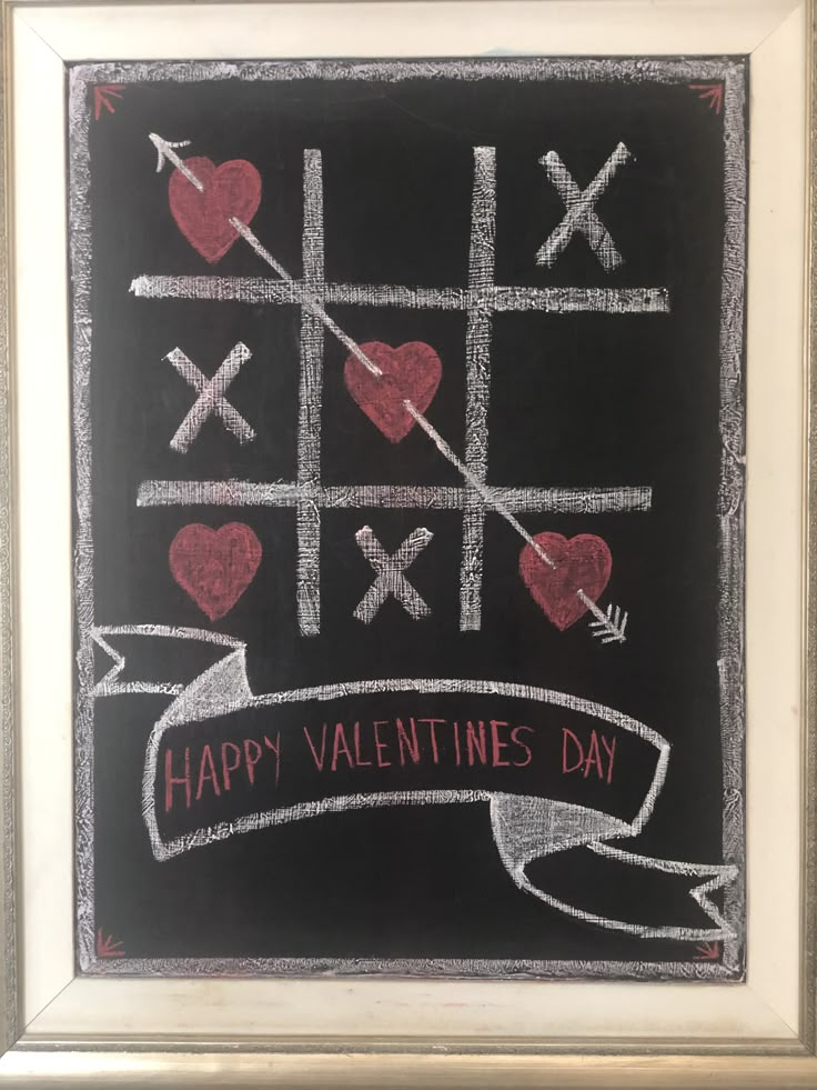 a chalk board with hearts and crosses drawn on it, says happy valentine's day