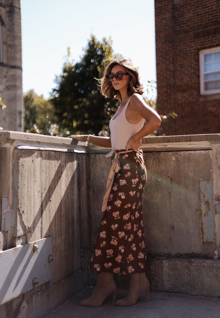 Indulge in the beauty and sophistication of our Chestnut Flora Skirt. Crafted with the finest materials, this skirt boasts a stunning chestnut floral pattern that will elevate any outfit. Fabric 100% polyester side zipper Brown Floral Maxi Skirt Outfit, Summer Floral Print Brown Skirt, Brown Floral Ruffle Tier Midi Skirt, Flowy Brown Floral Print Skirt, Flora Skirt, Brown Non-stretch Midi Skirt, Side Zipper, Chestnut, Floral Pattern