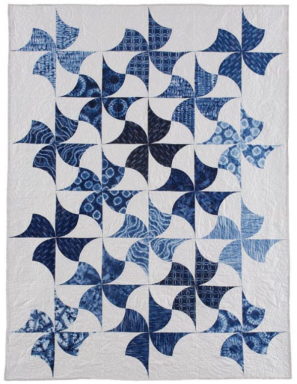 a blue and white quilt on display