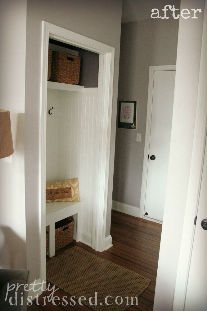 an image of a white closet in the corner of a room with wood flooring