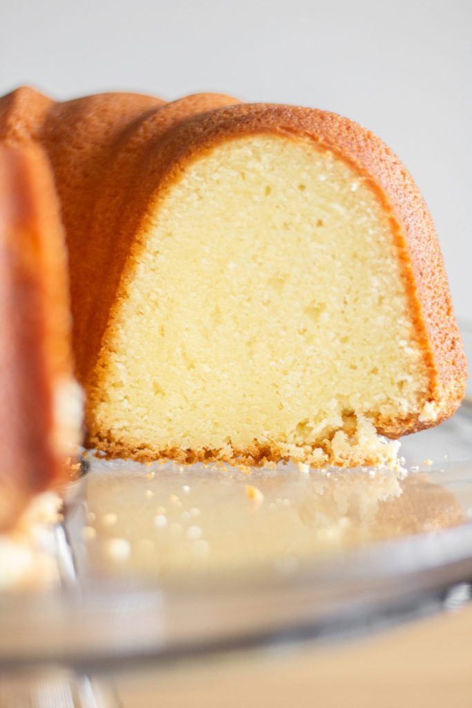 a bundt cake on a plate with one slice cut out