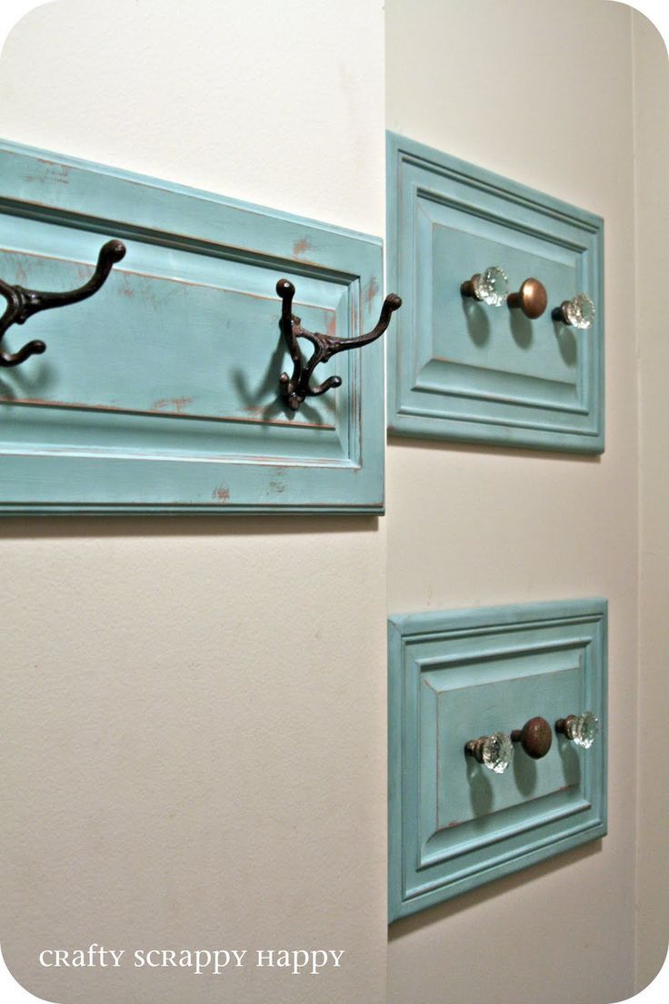 two hooks are attached to the side of a wall with knobs and handles on them