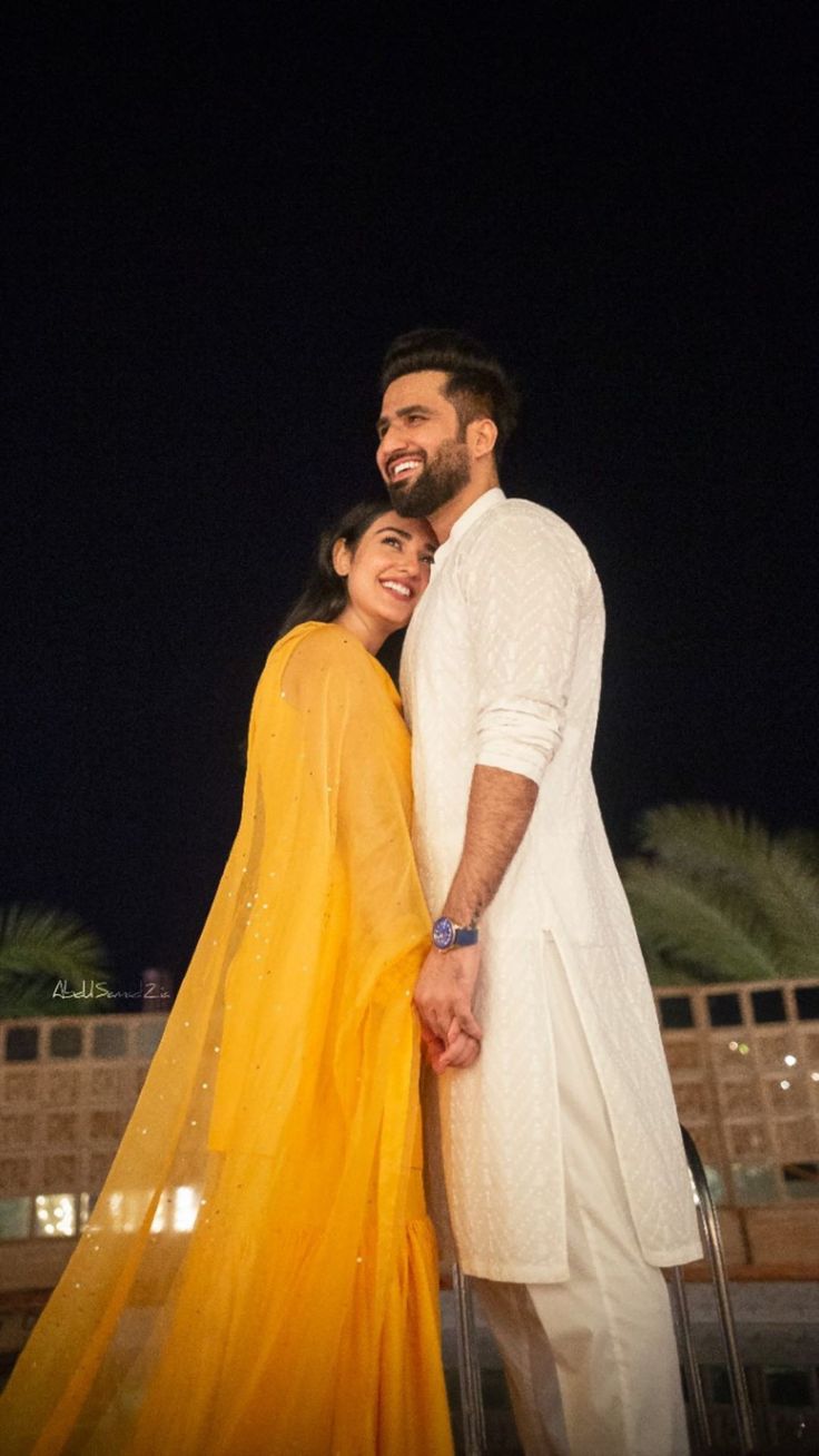 two people standing next to each other in front of a building with the caption'i ammakabar official wishing you a lifetime of love and happiness '