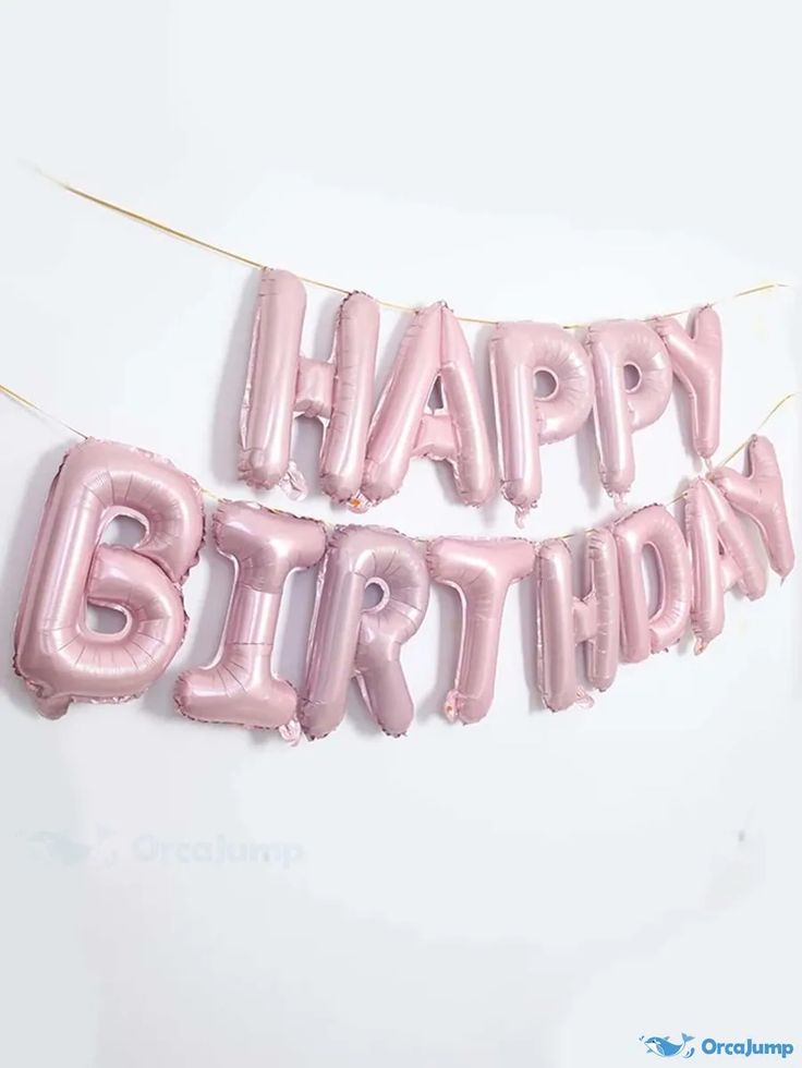 two pink balloons that say happy birthday hanging from a string on a white wall,