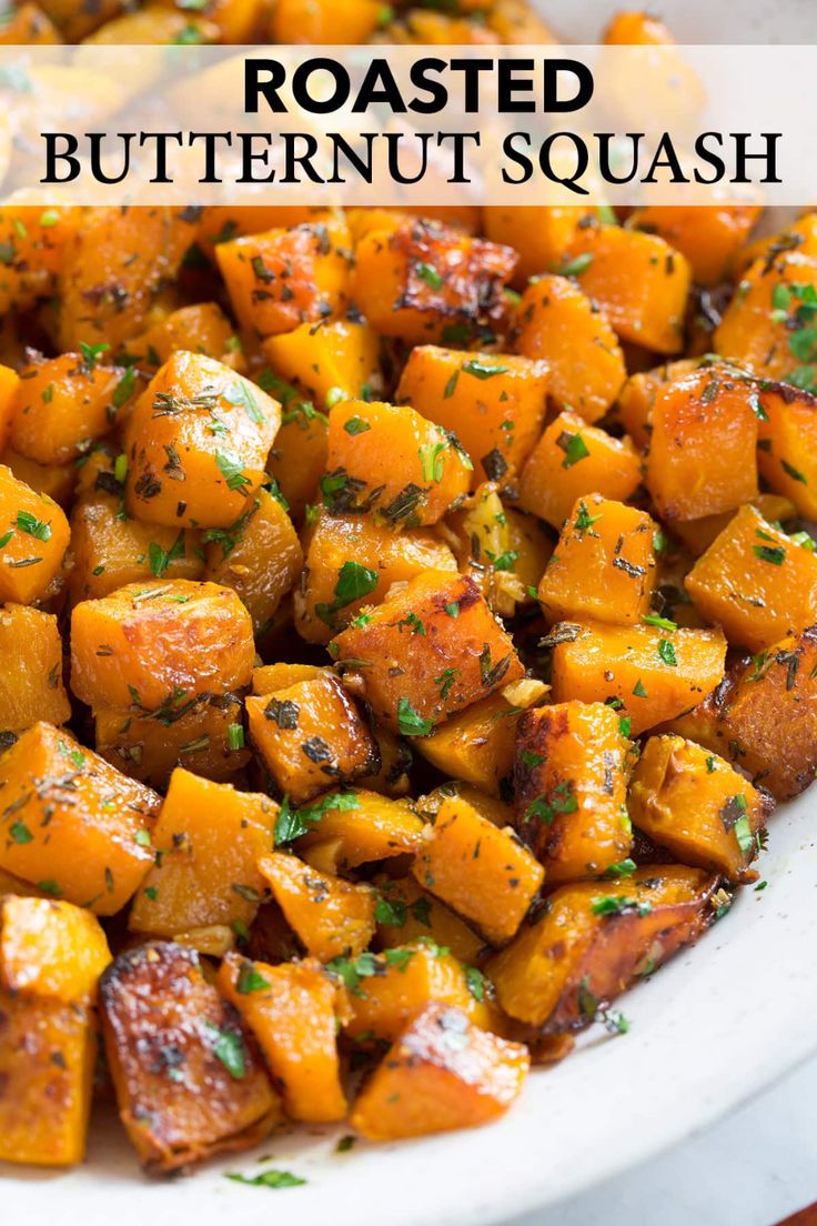 a white bowl filled with cooked sweet potatoes and garnished with fresh parsley