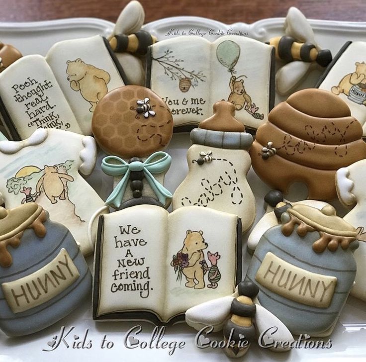 decorated cookies in the shape of winnie the pooh books and honey pots are on display