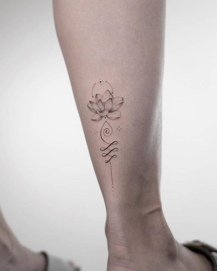 a woman's leg with a lotus tattoo on it