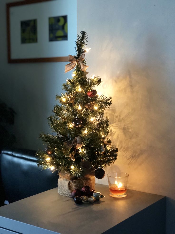 a small christmas tree sitting on top of a table