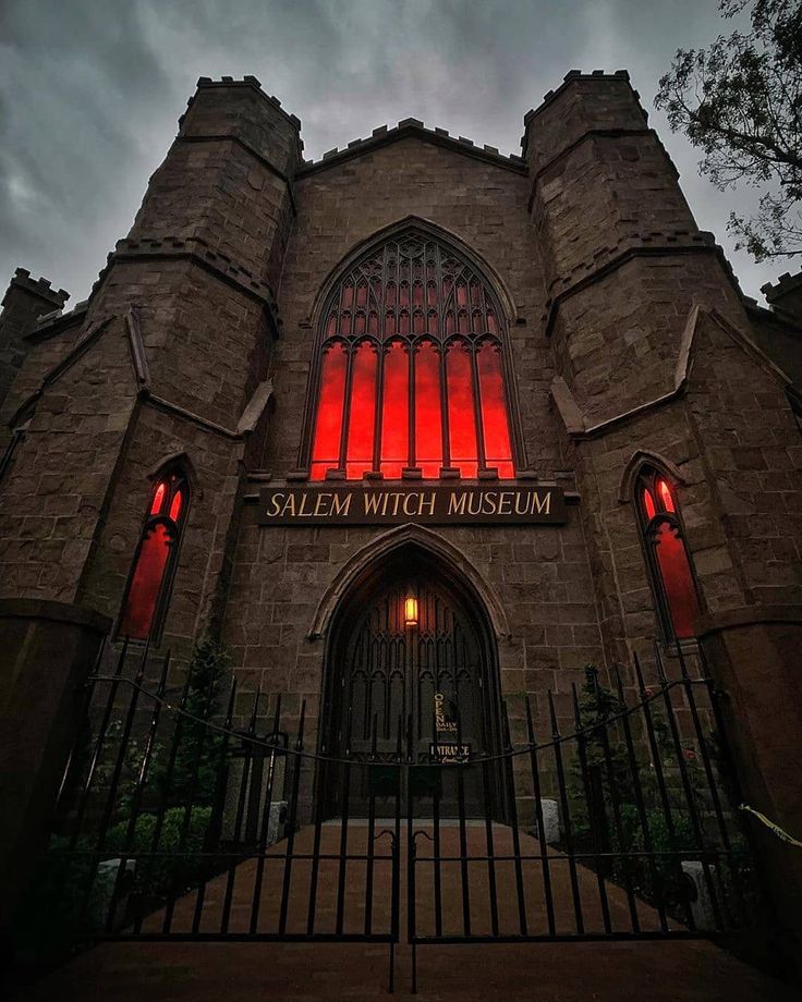 the salem witch museum is lit up in red for halloween season, and it's an amazing place to visit