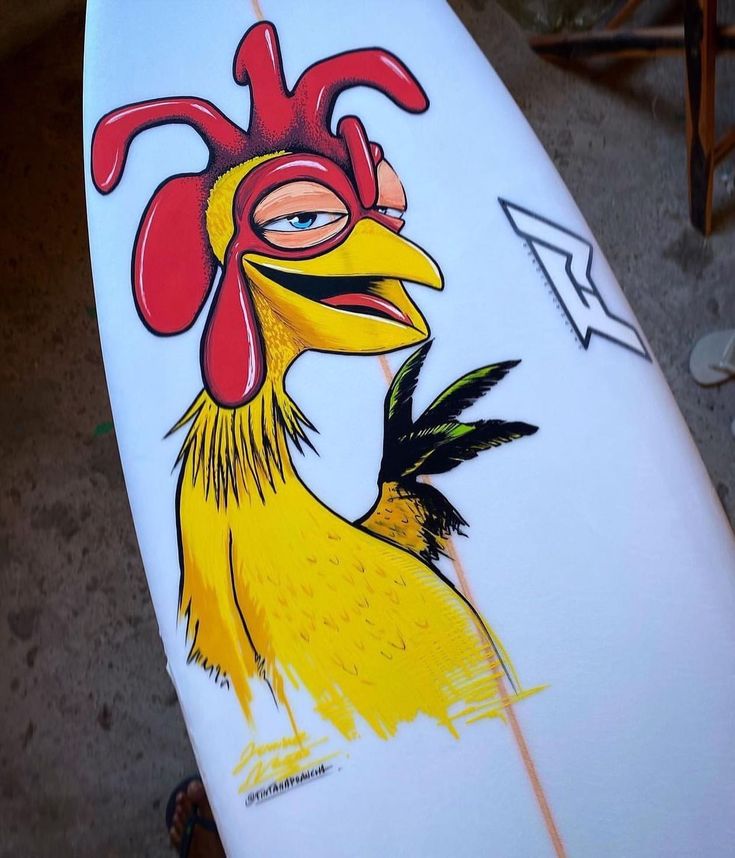 a surfboard with a drawing of a rooster on it