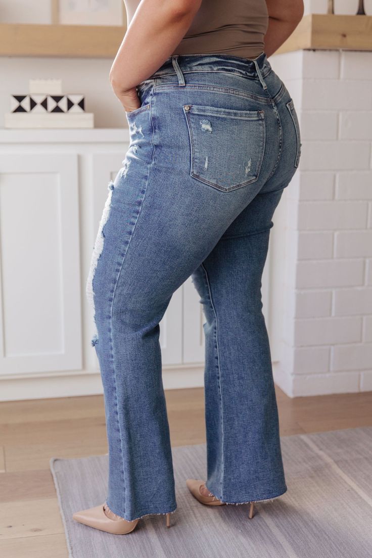 If you've got a flair for the dramatic, look no further than the Kiana Heavy Destroy Flare Jeans from Judy Blue! These amazing jeans feature a stretchy medium wash denim, that shapes a hi-rise with a five pocket cut, and zipper fly that drops into a heavy distressed leg with a raw flare hem. Pair these amazing jeans with a graphic tee, heeled boots, and a wide brim hat for a cute boho look!

Judy Blue
High Rise
Zip Fly
4-Way Stretch
Heavy Distressing
Wide Flare Leg
94% Cotton, 5% Polyester, 1% S Mid-rise Distressed Medium Wash Flare Jeans, Mid-rise Distressed Denim Blue Flare Jeans, High Rise Dark Wash Denim Flares, Fall Denim Distressed Flares, Fall Distressed Medium Wash Flares, Fall Distressed Denim Flares, Flare Distressed Denim Blue Jeans, Medium Wash Denim Flares For Fall, Non-stretch High Rise Medium Wash Flare Jeans