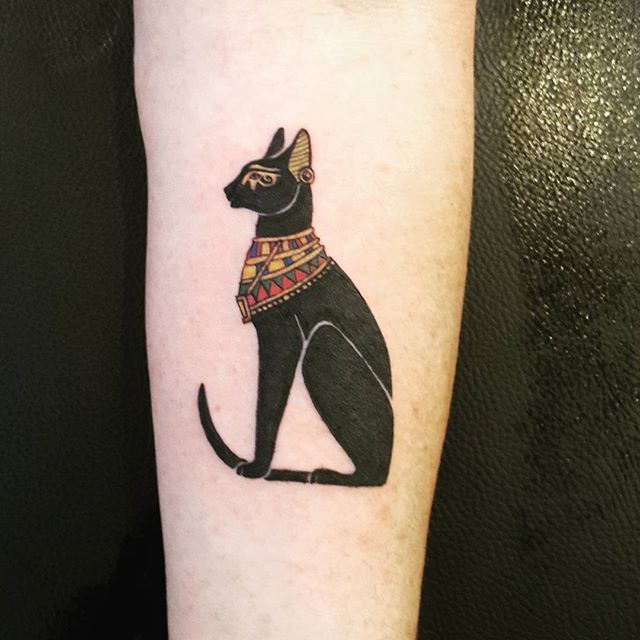 an egyptian cat tattoo on the arm