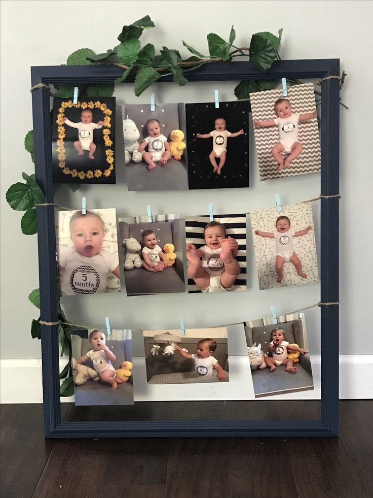 a blue frame with pictures hanging on it and candles in front of it that have photos pinned to them