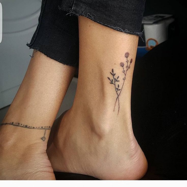 two people with matching tattoos on their feet, one has a flower tattoo on the other