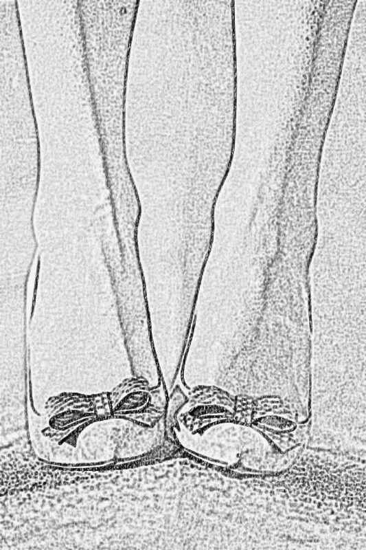 an old black and white photo of someone's feet