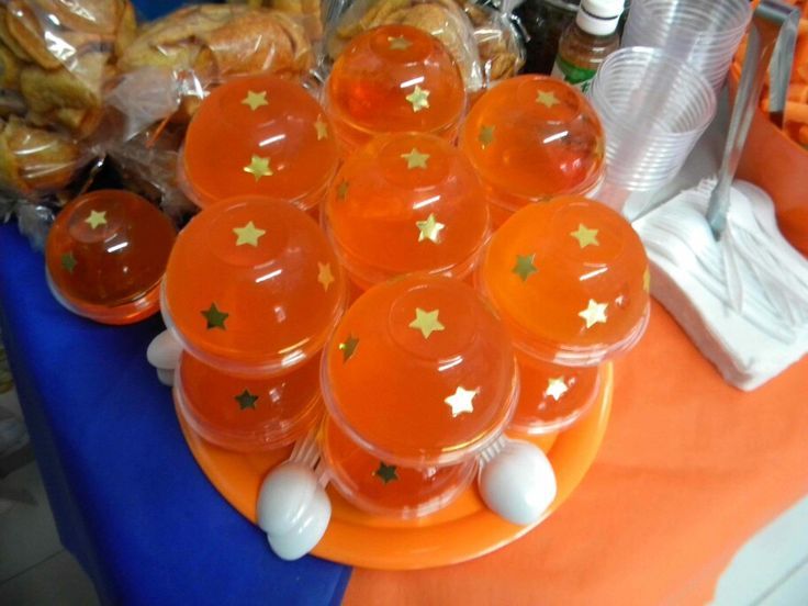 orange cups with gold stars on them sitting on an orange plate