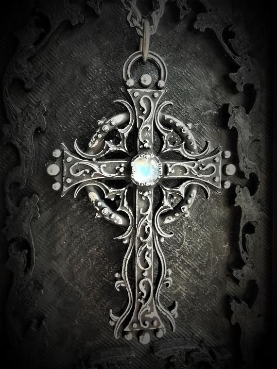 This Gothic cross necklace is an handmade pewter sculpture orned with a real gem (My fav is the Black star Diopside, seriously)This gothic necklace is sold with a very solid stainless steel chain of 18'' or 24'', if you would like to have a different length for the chain, you can write the desired length in the private note section when ordering :)This is a Gothic cross of 7cm This gothic cross necklace is a pewter sculpture of my own creation, i create and work the metal by myself at home. The Spiritual Cross Jewelry In Metal, Gothic Cross Necklace With Oxidized Finish, Gothic Oxidized Cross Necklace, Oxidized Metal Cross Pendant Jewelry, Gothic Cross Pendant Necklace With Engraving, Gothic Silver Pendant Cross Necklace, Gothic Silver Necklaces With Antique Finish, Gothic Stainless Steel Cross Pendant Jewelry, Spiritual Metal Cross Pendant Necklace