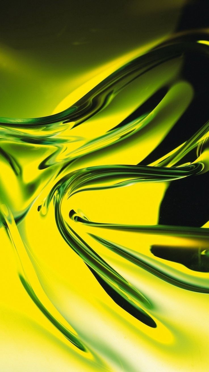 green and yellow liquid swirls on a black table top, with the light reflecting off it's surface