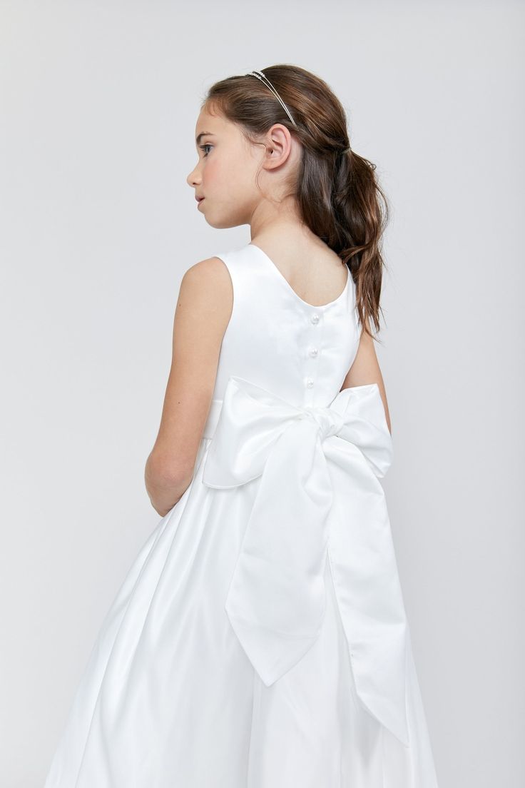 Please note: This is for the dress only. The Satin Tank Dress is made of gorgeous bridal satin, which is heavier and more elegant than ordinary satin. The dress is fully lined, and is designed and lovingly made to be soft, and comfortable, so that your little one can shine. The dress is a tea-length gown. Available in both white and ivory. Complete the look by choosing a sash that matches the dress or one that matches your bridal party. This dress is one our iconic Us Angels Flower Girl styles, White Satin Dress, Girls Communion Dresses, Upscale Fashion, Girls Dress Shop, Be Soft, Satin Sash, Communion Dresses, Bridal Designs, Tea Length