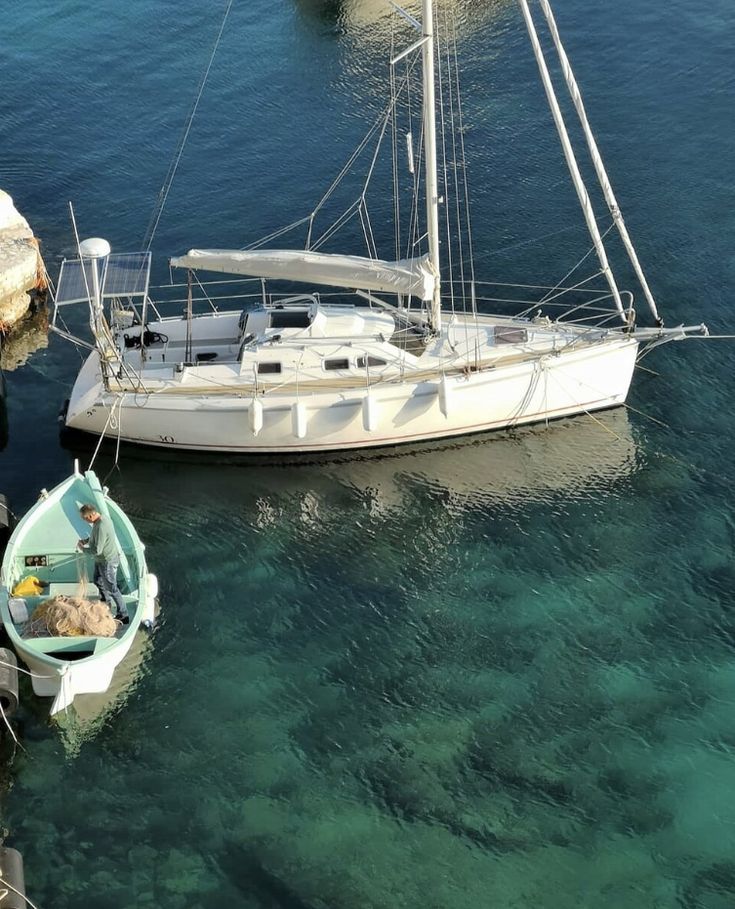 two boats in the water next to each other