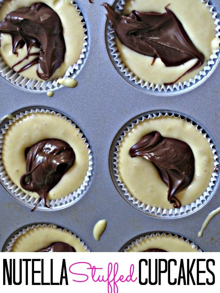 cupcakes with chocolate frosting in muffin tins on top and the words nutella stuffed cupcakes above them