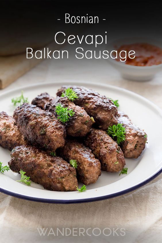 a white plate topped with meat covered in sauce