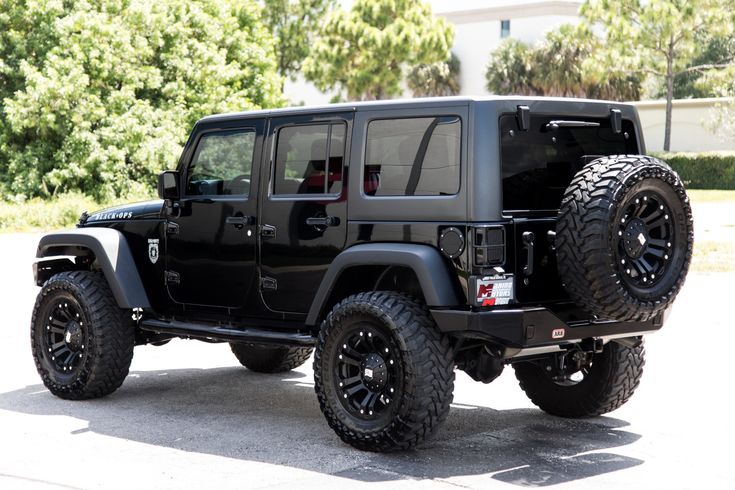 a black jeep is parked in the parking lot