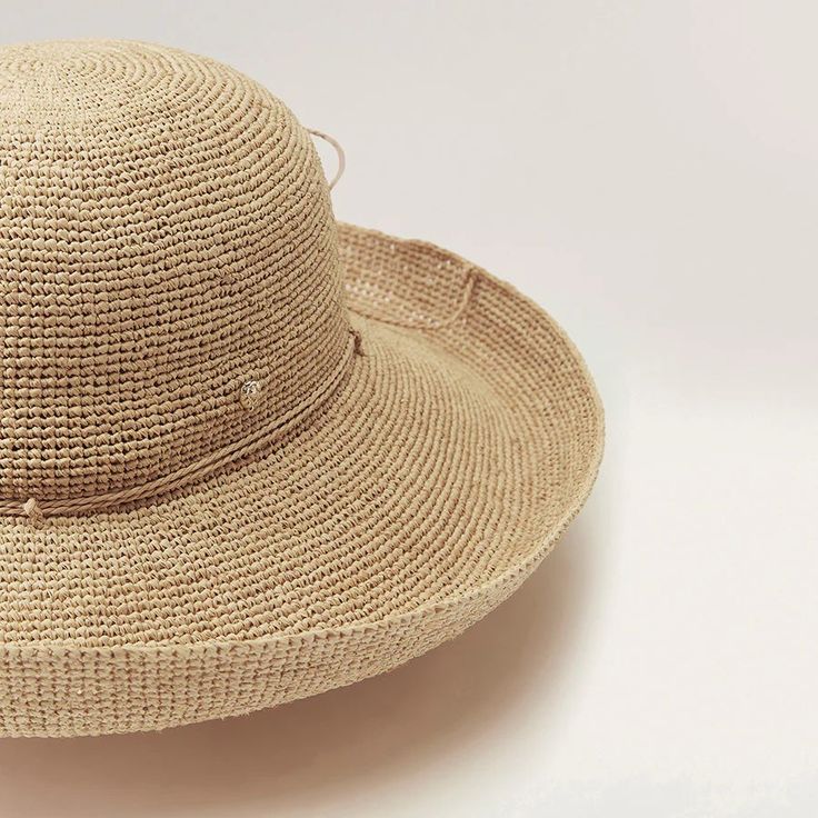 The Provence is a hallmark Helen Kaminski hat with a 12cm brim that can be styled up or down. Featuring a hand rolled raffia tie for adjustable sizing and a neoprene band for comfort, this style rolls to pack making it a perfect travel accessory. With over 14,000 stitches of sustainably harvested Madagascan raffia and taking over three days to complete, the Provence displays the true art form of artisanal handcraft with subtle variations being unique to each hat. We source the finest, sustainably harvested Madagascan raffia that is hand selected, washed or dyed and seamlessly crocheted with no visible seams, knots or joins. Raffia has a natural resin making it innately soft, supple and resilient; Unlike straw, raffia has longevity and won't crack or get brittle over time. Applying light st Elegant Bucket Hat For Travel, Elegant Adjustable Woven Hat Bands, Elegant Woven Travel Hat, Classic Adjustable Straw Bucket Hat, Adjustable Wide Brim Cloche Hat, Chic Adjustable Boater Hat For Travel, Elegant Woven Straw Bucket Hat, Elegant Adjustable Woven Boater Hat, Adjustable Curved Brim Cloche Hat For Travel