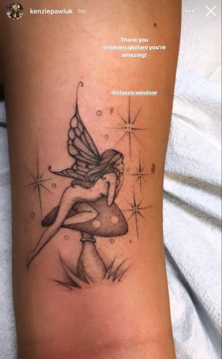 a tattoo with a fairy sitting on top of a mushroom