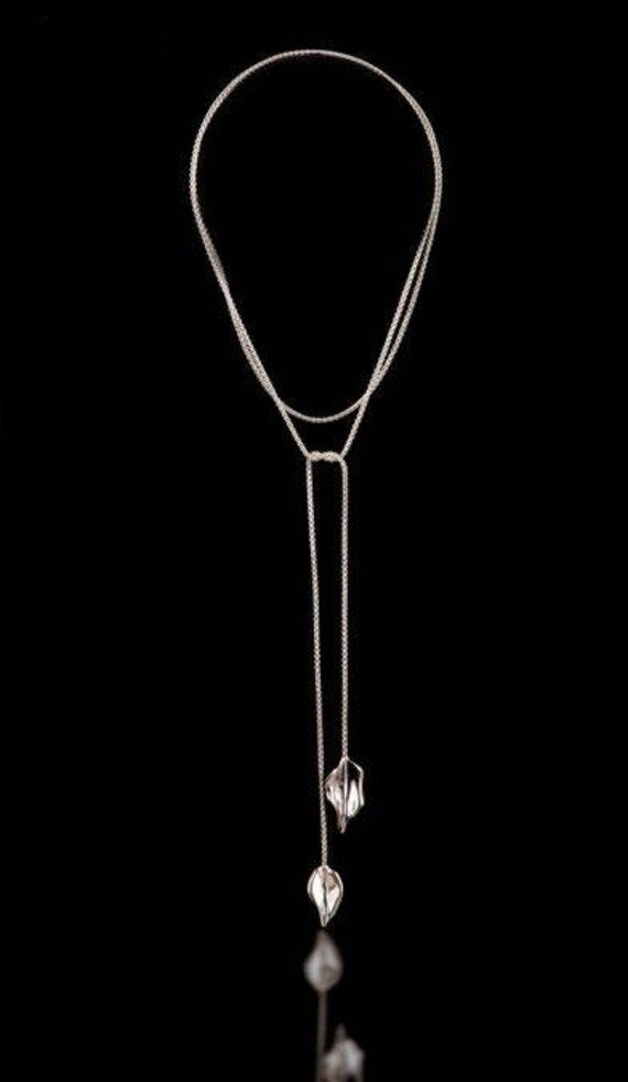 This Sterling Silver Two Leaf Lariat is flexible, easy to wear and comfortable and can be worn a couple of different ways because it has such a long chain. It can be made in 18kt Gold as well. It looks really relaxed and chic. The leaves are made by casting and soldered to the chain. The Chain is 1.2 mm in thickness so it is a dainty and delicate look. Very feminine. Chic Silver Lariat Necklace With Delicate Chain, Silver Chain Lariat Necklace, Elegant Lariat Necklace With Double Chain As Gift, Adjustable Silver Lariat Chain Necklace, Elegant Double Chain Lariat Necklace As Gift, Elegant Double Chain Lariat Necklace Gift, Chic Silver Lariat Necklace With Adjustable Chain, Formal Lariat Long Necklace With Adjustable Chain, Elegant Adjustable Drop Chain Necklace